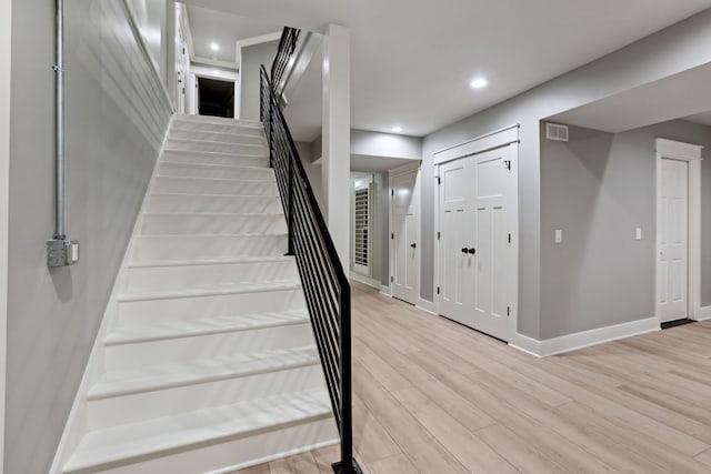 staircase featuring hardwood / wood-style flooring