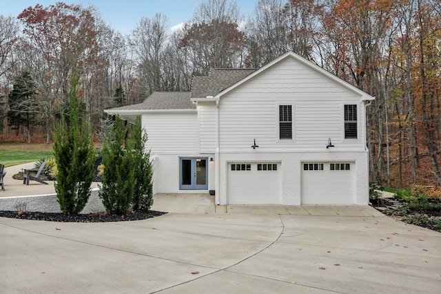 view of home's exterior with french doors and a garage