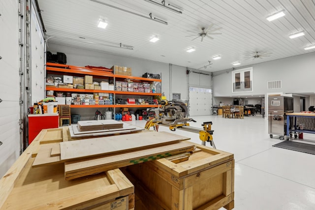 garage featuring a workshop area and ceiling fan