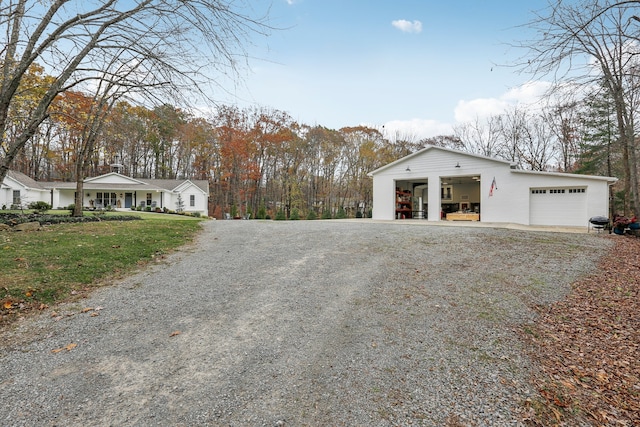 view of property exterior with covered porch and a garage