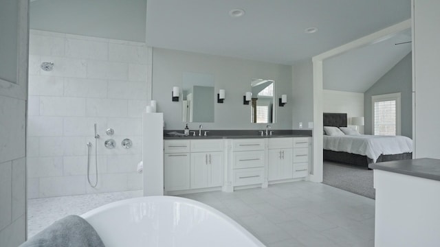 bathroom featuring vanity, shower with separate bathtub, and vaulted ceiling