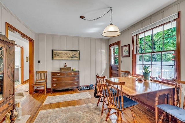 dining room with light hardwood / wood-style floors and ornamental molding