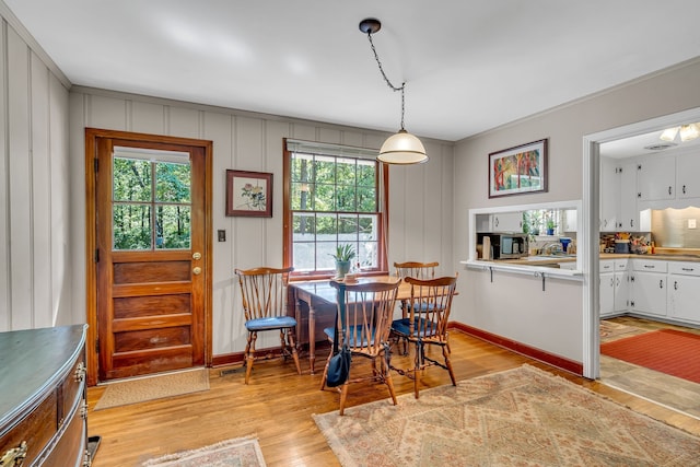 dining space with light hardwood / wood-style flooring and plenty of natural light