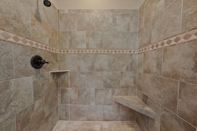 bathroom with tiled shower