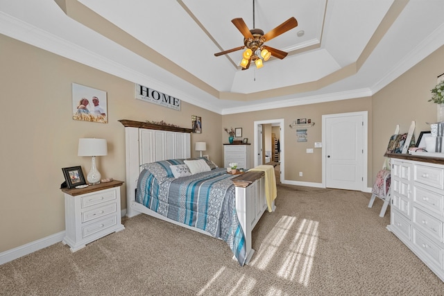 carpeted bedroom with a raised ceiling, ceiling fan, and ornamental molding