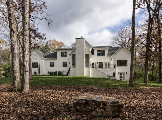 back of property featuring a lawn