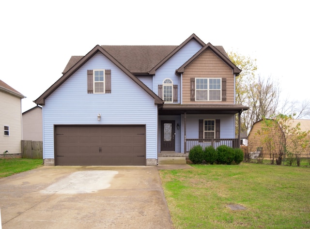 view of front of property featuring covered porch, a garage, and a front yard