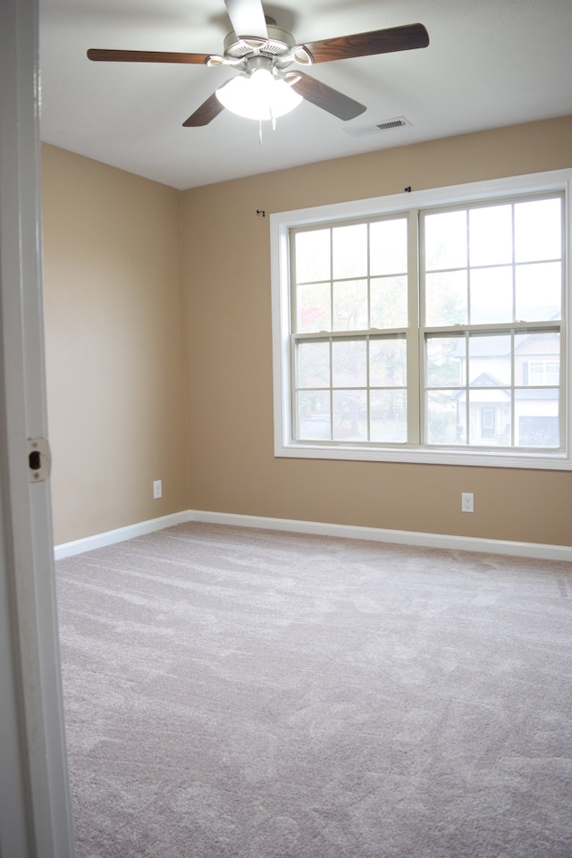 carpeted empty room with ceiling fan