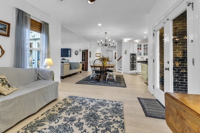 living room featuring light hardwood / wood-style floors and a notable chandelier