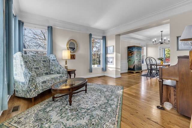 living room featuring wood-type flooring and ornamental molding