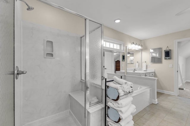 bathroom with tile patterned flooring, vanity, and plus walk in shower