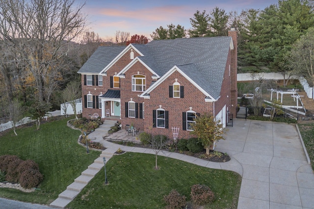 view of front of house featuring a lawn and a garage