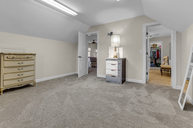 bonus room featuring light carpet and vaulted ceiling