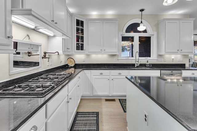 kitchen with white cabinetry, sink, and hanging light fixtures