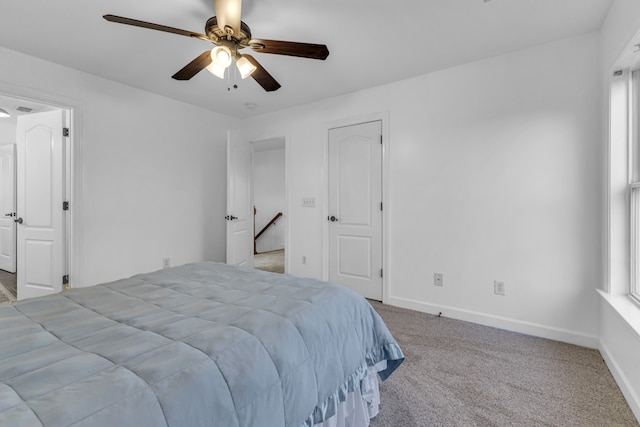 bedroom featuring light carpet and ceiling fan