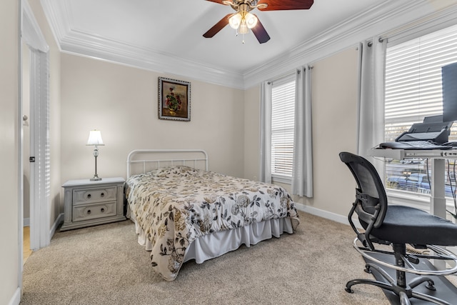 carpeted bedroom featuring ceiling fan and crown molding