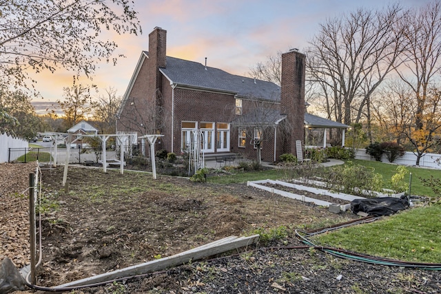 back house at dusk featuring french doors