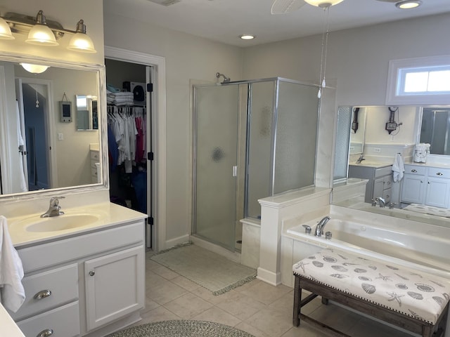 bathroom with tile patterned flooring, vanity, and shower with separate bathtub