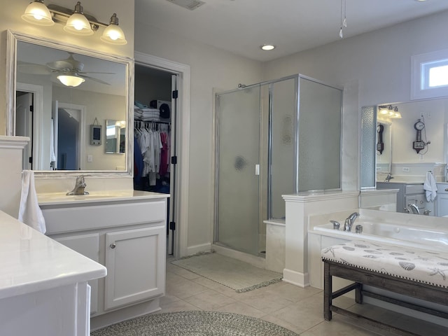 bathroom featuring tile patterned floors, ceiling fan, walk in shower, and vanity