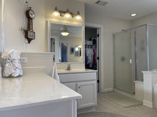 bathroom featuring vanity, tile patterned floors, walk in shower, and ceiling fan