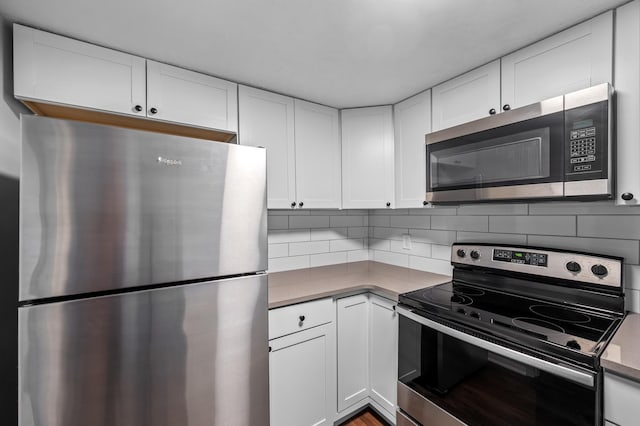 kitchen featuring white cabinetry, decorative backsplash, and appliances with stainless steel finishes