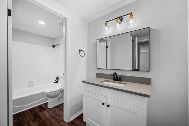 full bathroom featuring vanity, toilet, hardwood / wood-style floors, and shower / bathing tub combination