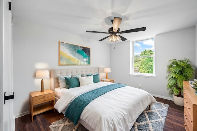 bedroom with dark hardwood / wood-style floors and ceiling fan