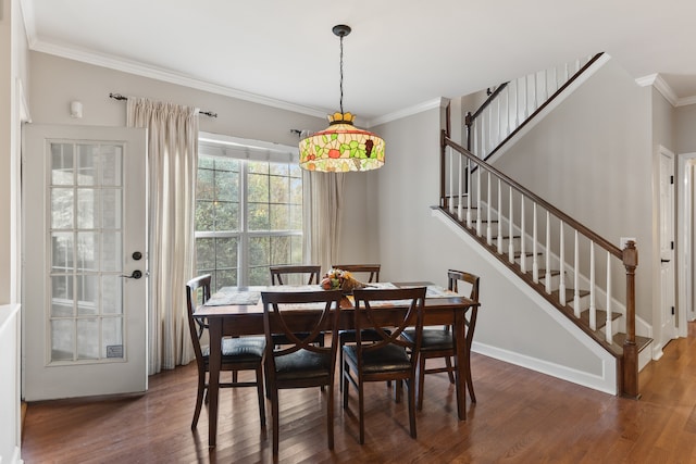 dining space with ornamental molding and dark wood-type flooring