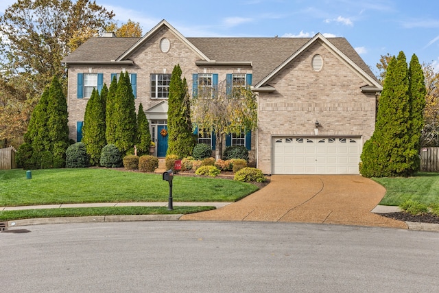 view of front of home with a garage and a front lawn