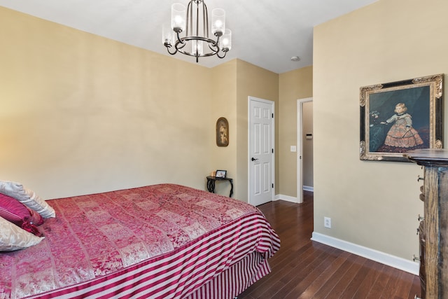 bedroom with a chandelier and dark wood-type flooring