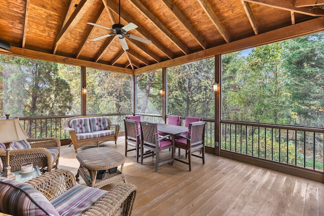 sunroom / solarium featuring vaulted ceiling with beams, ceiling fan, and wood ceiling