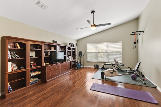 exercise room featuring ceiling fan, wood-type flooring, and vaulted ceiling