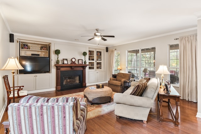 living room with dark hardwood / wood-style floors, ceiling fan, and ornamental molding