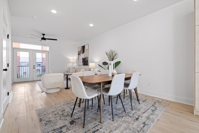 dining area with ceiling fan, french doors, and light wood-type flooring