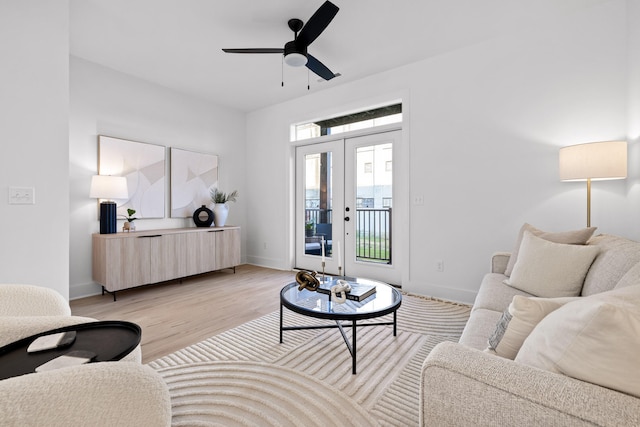 living room with ceiling fan and light hardwood / wood-style floors