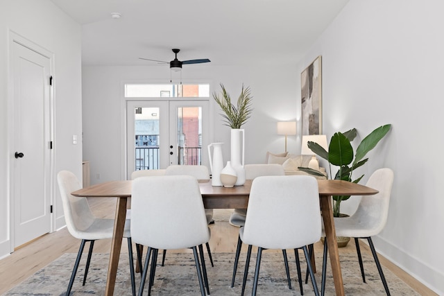 dining area with french doors, light wood-type flooring, and ceiling fan