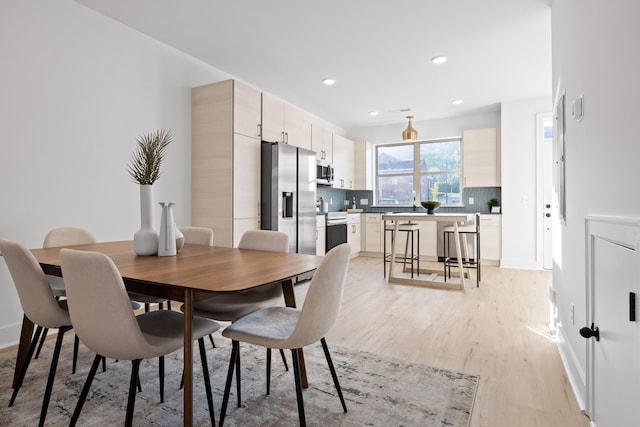 dining room with light hardwood / wood-style flooring