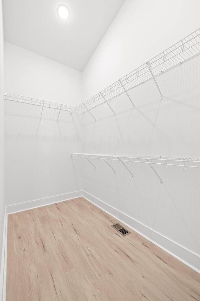 walk in closet featuring hardwood / wood-style flooring