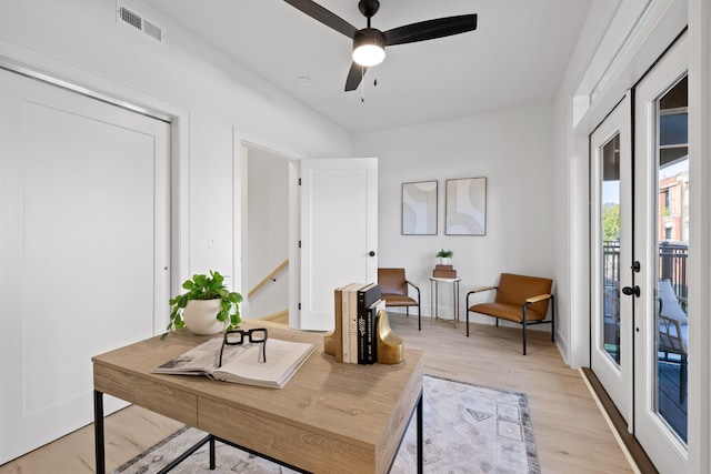 office with ceiling fan, french doors, and light hardwood / wood-style floors