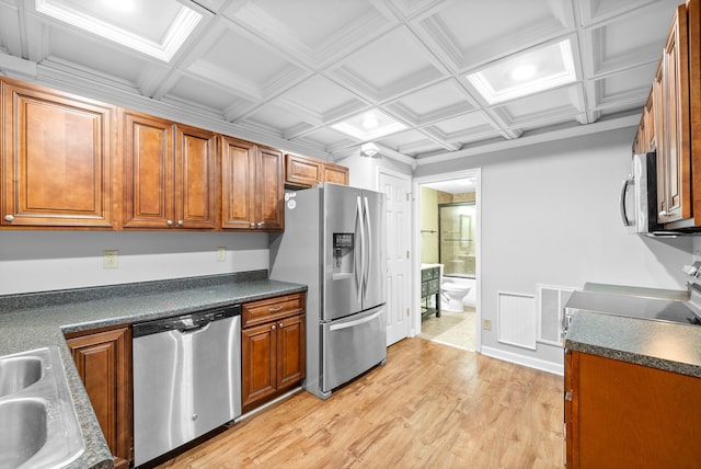 kitchen featuring beam ceiling, coffered ceiling, light hardwood / wood-style floors, appliances with stainless steel finishes, and ornamental molding