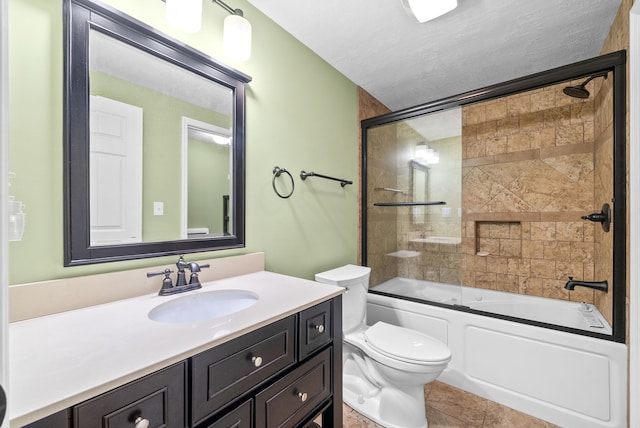 full bathroom with vanity, tile patterned floors, bath / shower combo with glass door, toilet, and a textured ceiling