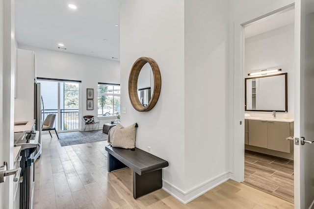 hallway with light hardwood / wood-style floors