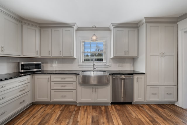 kitchen featuring dark hardwood / wood-style floors, sink, decorative backsplash, and stainless steel appliances