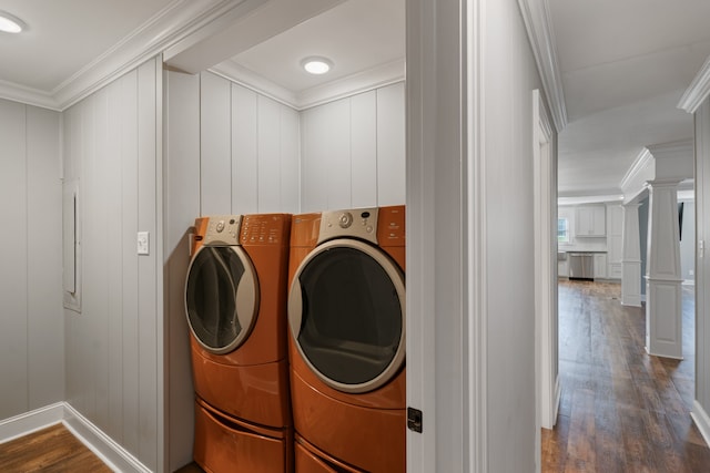 washroom with dark hardwood / wood-style floors, separate washer and dryer, and crown molding