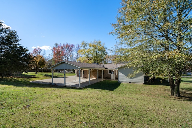 back of property with a yard and a patio