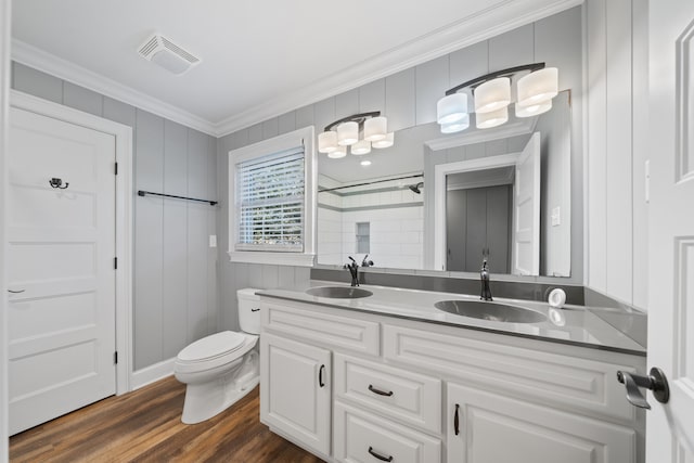 bathroom with crown molding, toilet, vanity, and hardwood / wood-style flooring