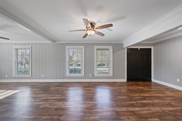 unfurnished living room with ornamental molding, ceiling fan, wooden walls, beamed ceiling, and dark hardwood / wood-style floors