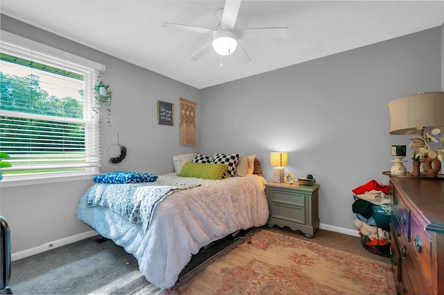 bedroom featuring ceiling fan and light carpet