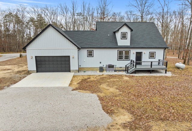 view of front of house with a garage and central air condition unit