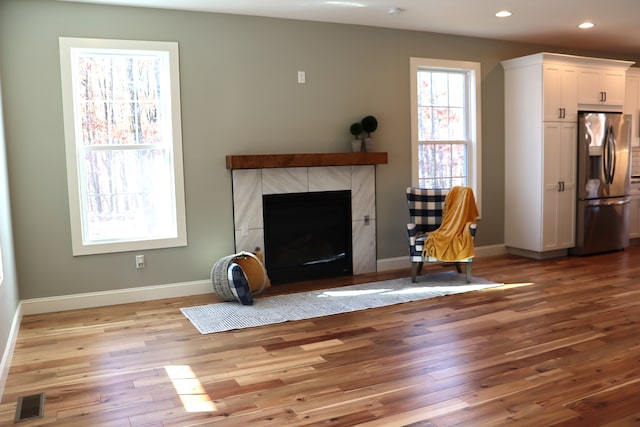 unfurnished living room with a fireplace and light hardwood / wood-style flooring